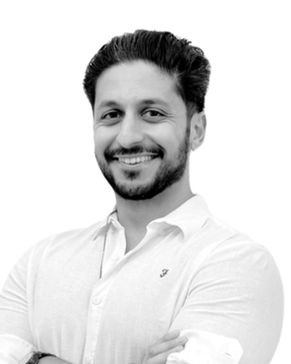 Haydar Munthadar, smiling, arms folded.