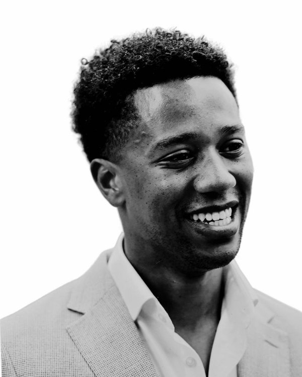Jordan Clarke, smiling and looking to the side.
